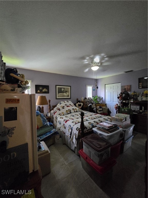 bedroom with ceiling fan and a textured ceiling