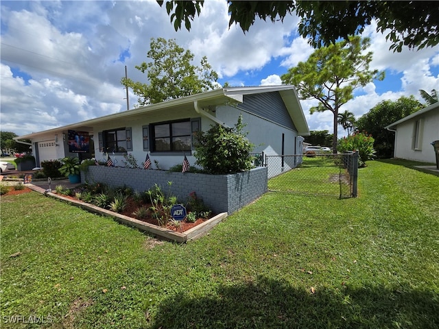 view of property exterior featuring a lawn and a garage