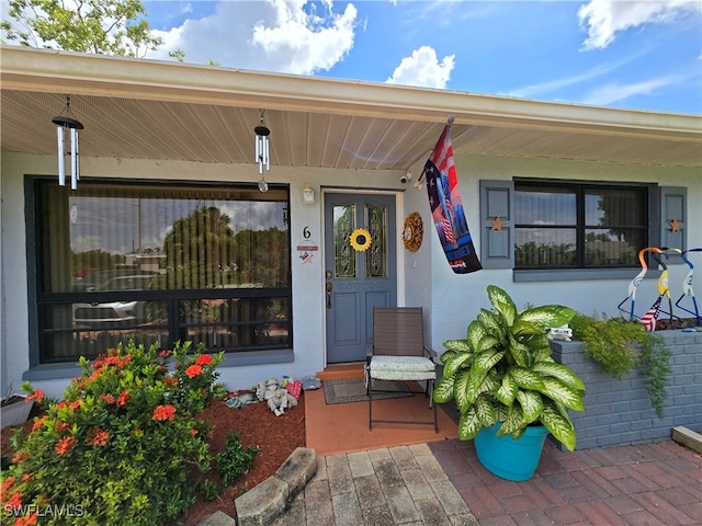 view of exterior entry featuring a porch