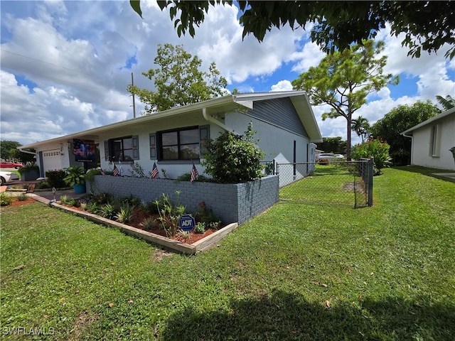 view of side of property featuring a yard and a garage