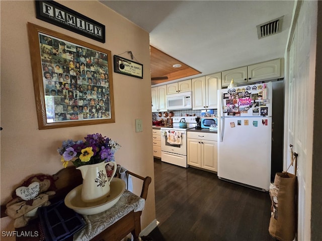 kitchen with decorative backsplash, white appliances, and dark hardwood / wood-style floors