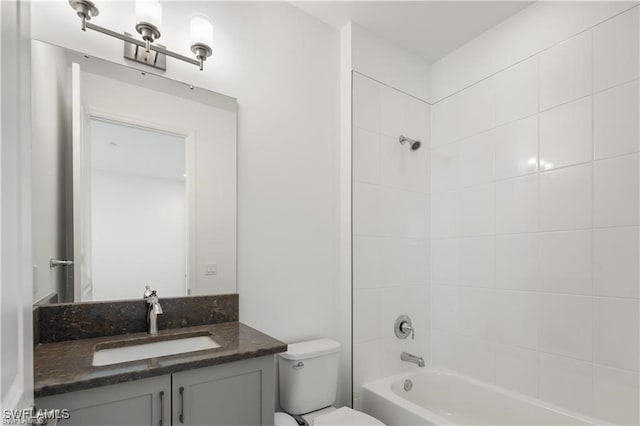 full bathroom featuring vanity, toilet, and tiled shower / bath