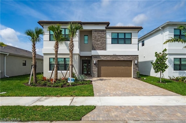 modern home featuring a garage and a front lawn