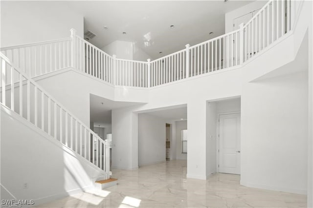 staircase featuring a high ceiling