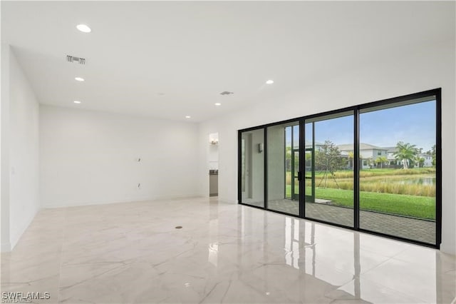 spare room featuring a water view