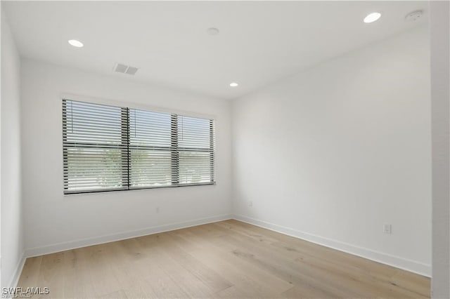 spare room featuring light hardwood / wood-style flooring