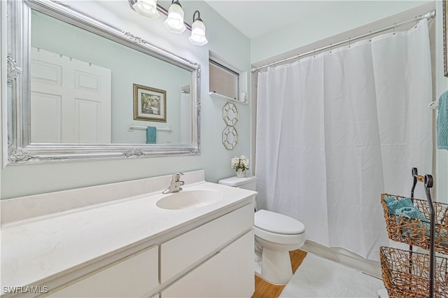 bathroom featuring hardwood / wood-style floors, vanity, toilet, and a shower with shower curtain