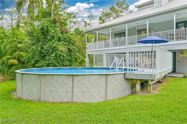 view of pool with a lawn