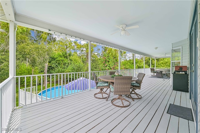 wooden deck featuring ceiling fan