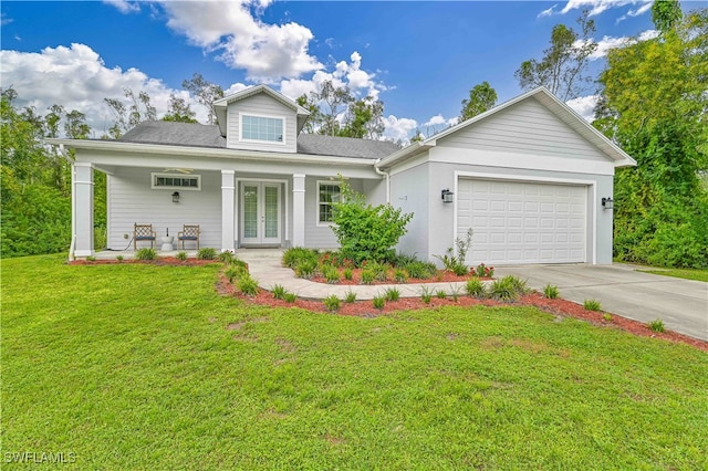 view of front of property with french doors, covered porch, a front yard, and a garage