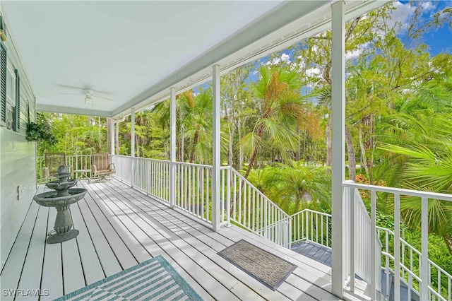 unfurnished sunroom with ceiling fan