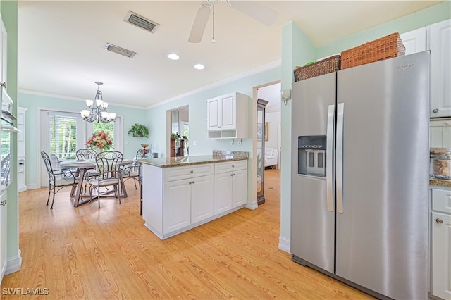 kitchen with white cabinets, stainless steel fridge, light wood-type flooring, and stone counters