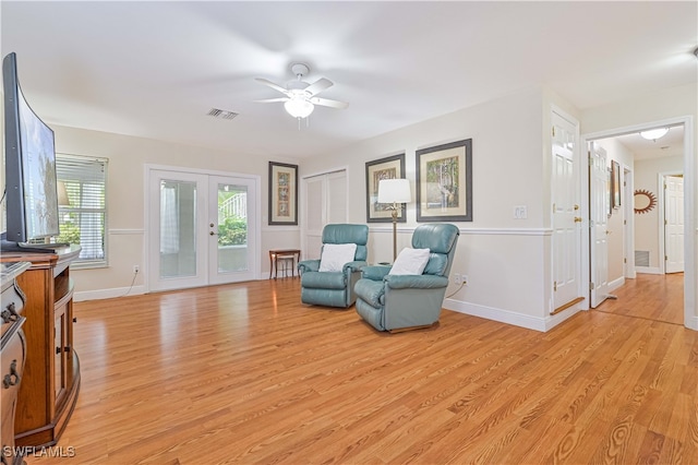 sitting room with ceiling fan, french doors, and light hardwood / wood-style floors