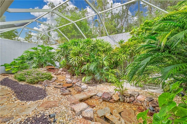 view of yard featuring glass enclosure