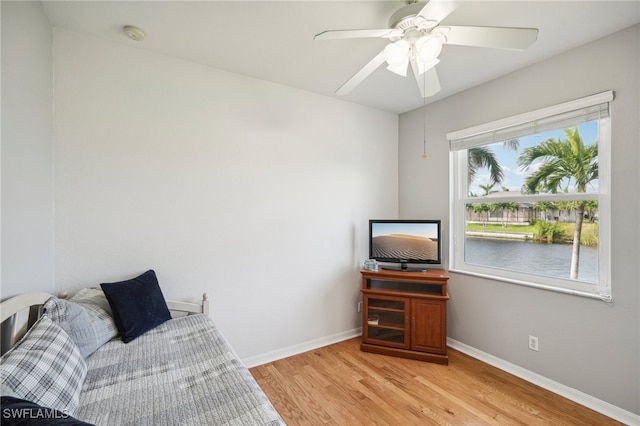 sitting room with ceiling fan and light wood-type flooring