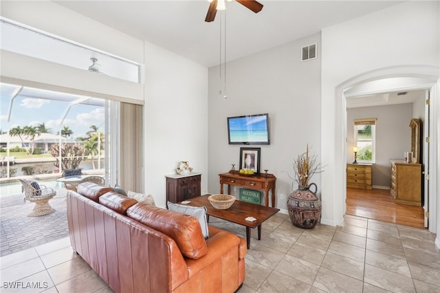 living room featuring light tile patterned floors and ceiling fan