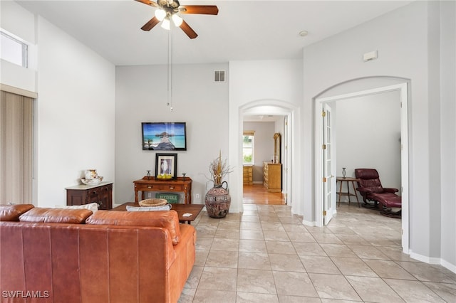 living room featuring ceiling fan and light tile patterned floors