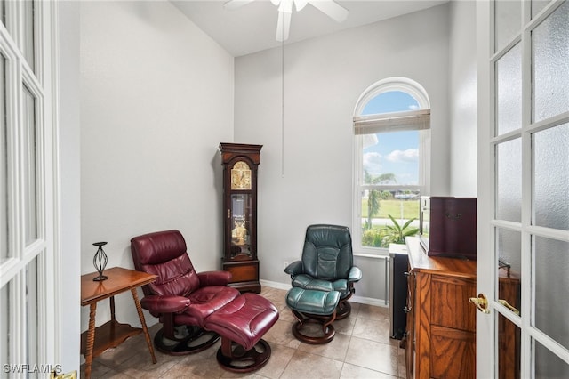 sitting room featuring ceiling fan, french doors, plenty of natural light, and light tile patterned flooring