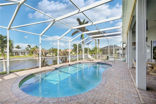 view of pool with a water view, a patio area, and a lanai