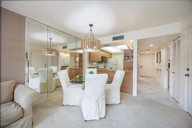 tiled dining area with a notable chandelier