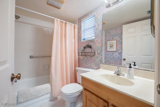 full bathroom featuring shower / bath combination with curtain, tile patterned floors, vanity, and toilet