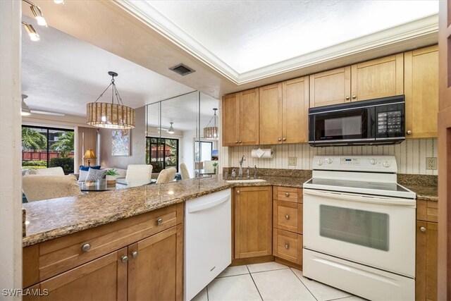 kitchen with white appliances, kitchen peninsula, pendant lighting, light tile patterned floors, and sink