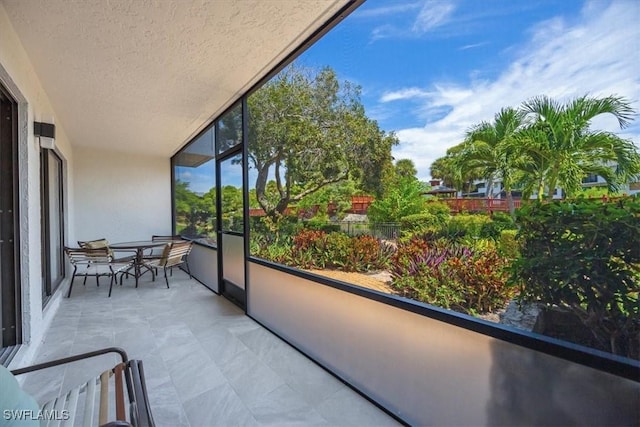 600 Neapolitan Way Unit 115, Naples, FL 34103 - sunroom with baseboards and a textured ceiling