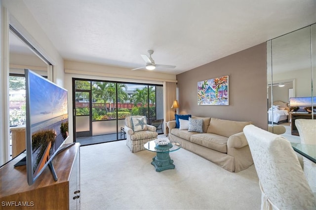 living room featuring ceiling fan and carpet floors