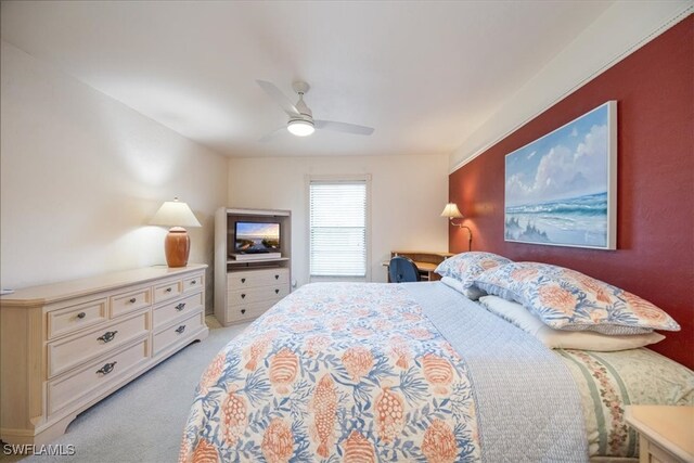 bedroom with ceiling fan and light colored carpet