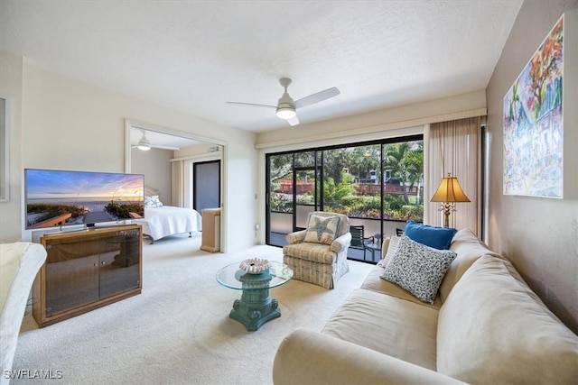 carpeted living room featuring ceiling fan