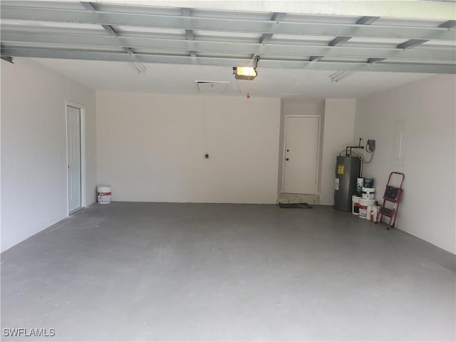 garage with a garage door opener and electric water heater