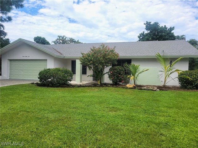 ranch-style home featuring a garage and a front lawn