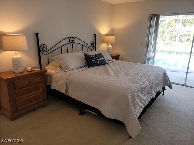 bedroom with access to exterior and light colored carpet