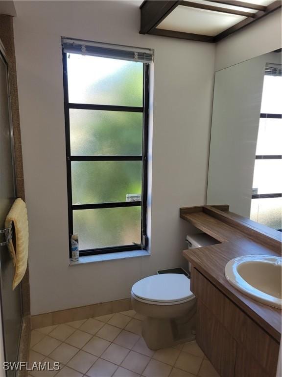 bathroom featuring tile patterned flooring, vanity, and toilet