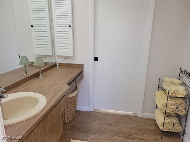 bathroom featuring hardwood / wood-style flooring and vanity