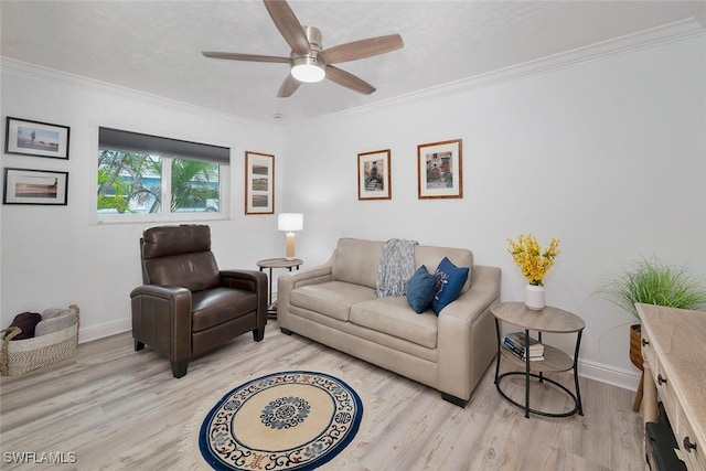 living room with ornamental molding, light wood-type flooring, and ceiling fan