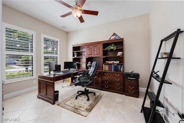 tiled home office featuring ceiling fan