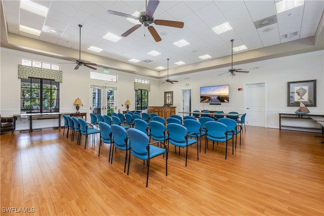 misc room with light wood-type flooring, a drop ceiling, a high ceiling, and french doors