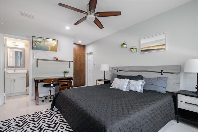 bedroom featuring built in desk, ensuite bath, sink, and ceiling fan