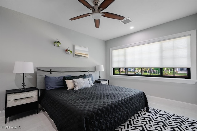 bedroom with multiple windows and ceiling fan