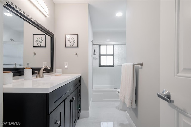 full bathroom featuring toilet, tiled shower / bath combo, and vanity