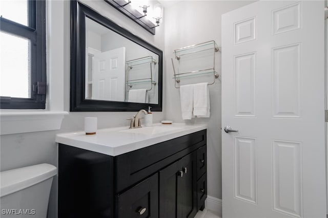 bathroom featuring toilet and vanity