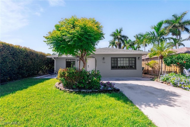 ranch-style home with a front lawn