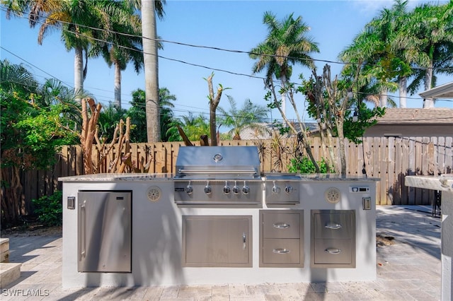 view of patio with a grill and an outdoor kitchen