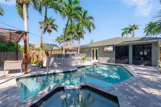 view of swimming pool featuring an in ground hot tub, a patio, and french doors