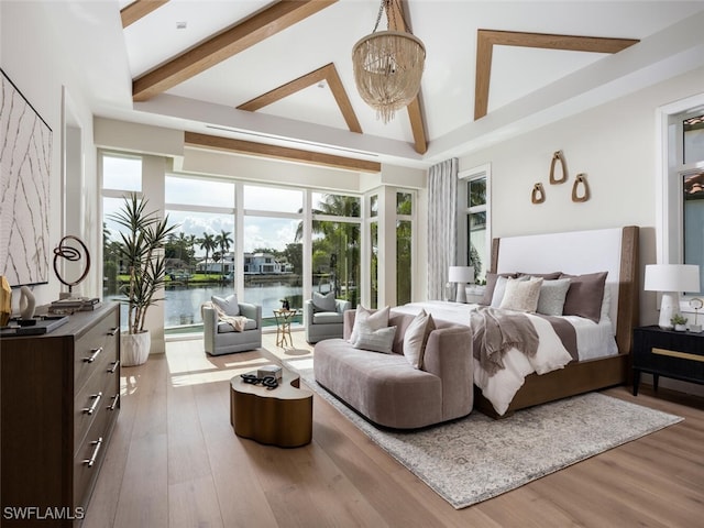 bedroom featuring hardwood / wood-style floors, a water view, high vaulted ceiling, and beamed ceiling