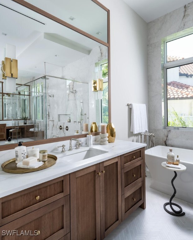 bathroom featuring tile walls, separate shower and tub, and vanity