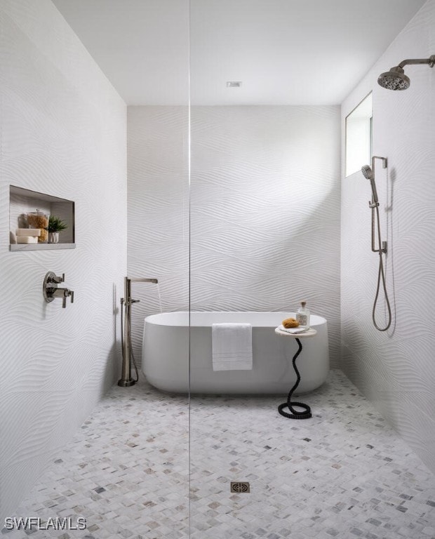 bathroom featuring separate shower and tub