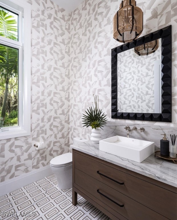 3131 Gin Ln, Naples, FL 34102 - half bath with wallpapered walls and vanity