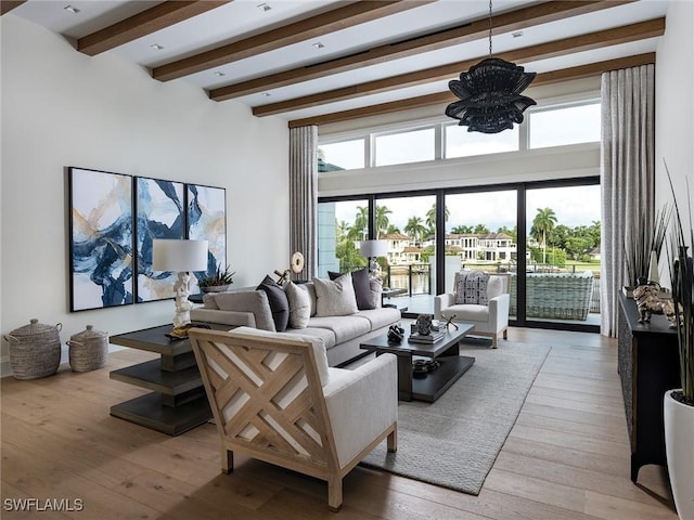 living room with a notable chandelier, beamed ceiling, and wood-type flooring